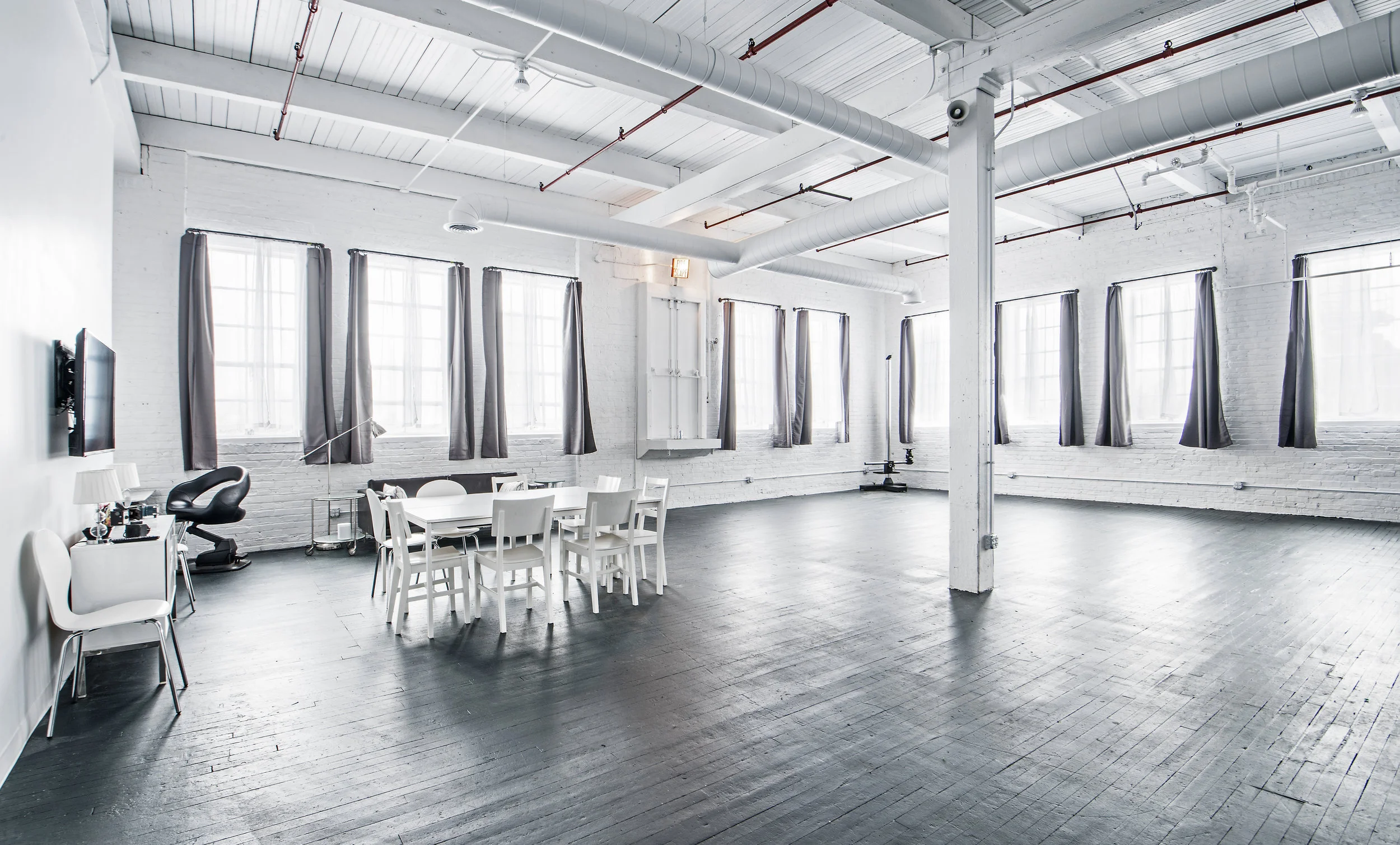 Open production floor at Stopover Studios with white ceilings and large windows